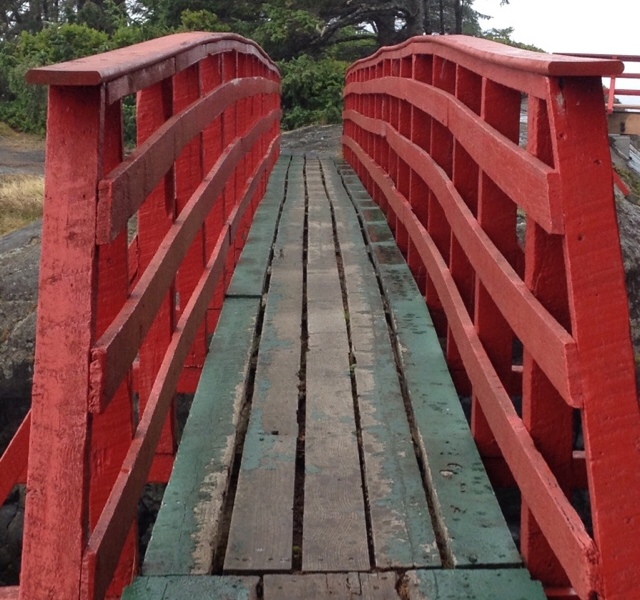 An old red and green footbridge connecting Point No Point to Vancouver Island